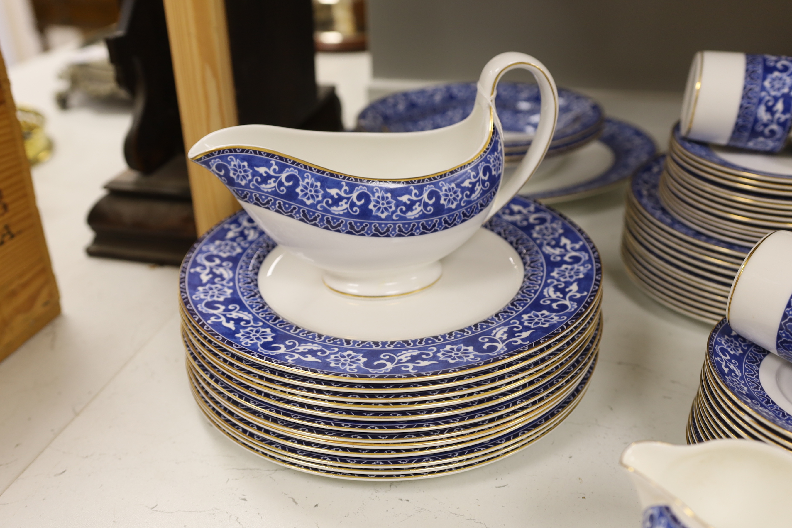 A Wedgwood Bokhara pattern 55 piece part dinner service, including a lidded vegetable tureen, a lidded sugar bowl, a cream jug, 12 dinner plates, 12 side plates, 12 dessert plates, 11 soup bowls, 3 pudding bowls and 2 ov